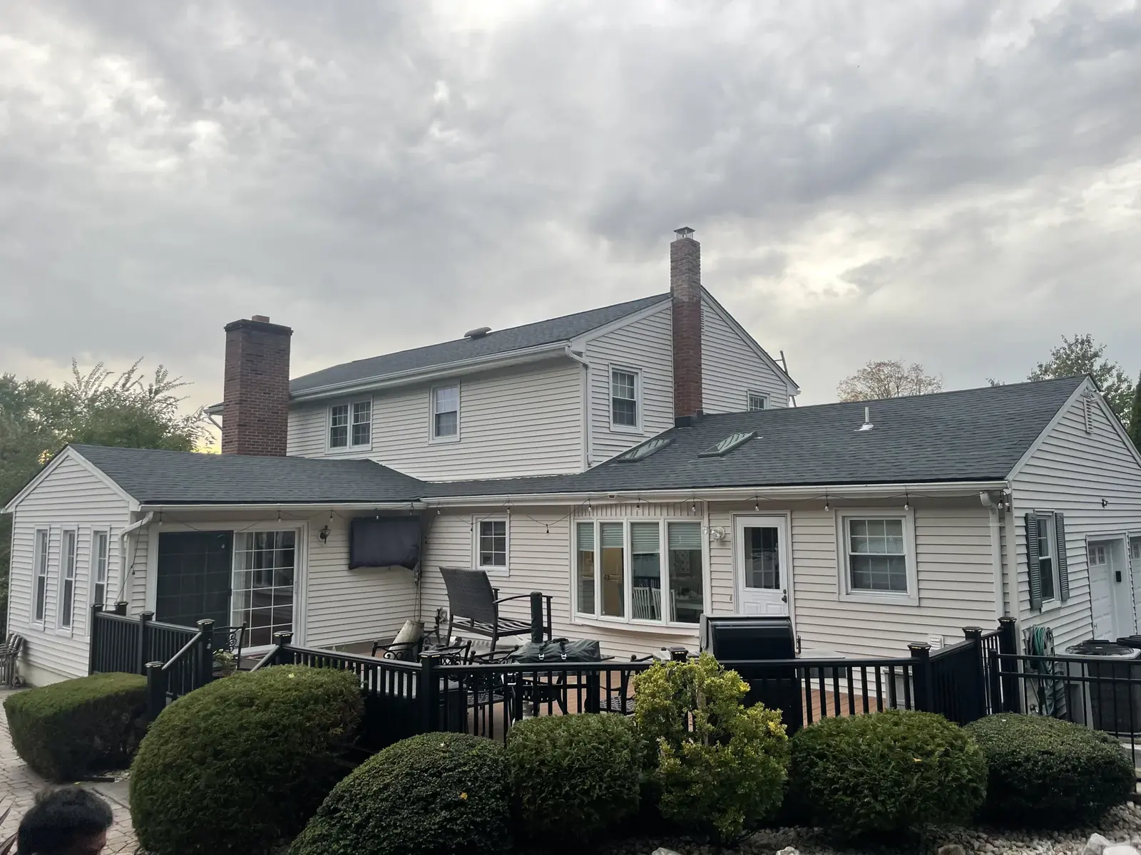A finished house exterior showing the completed roof and siding