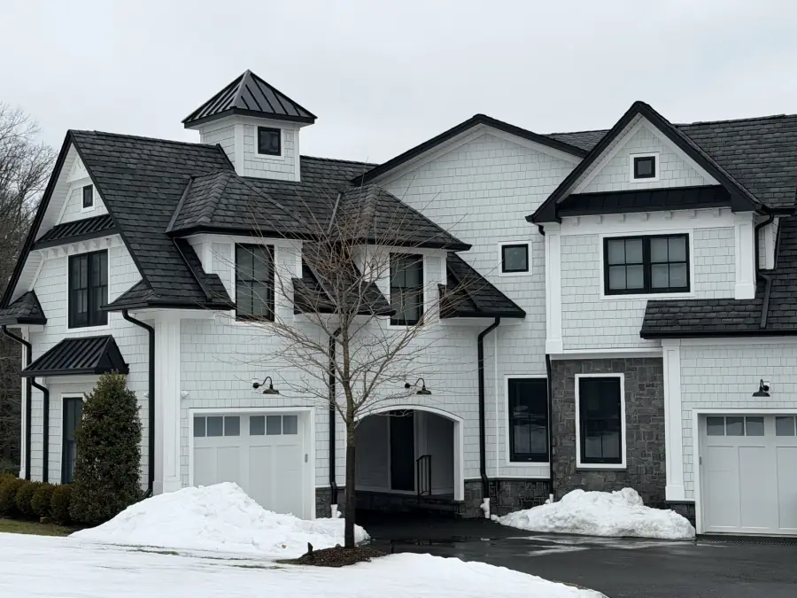 Farmhouse roof and black metal accents, roofing by Skyline Construction Group